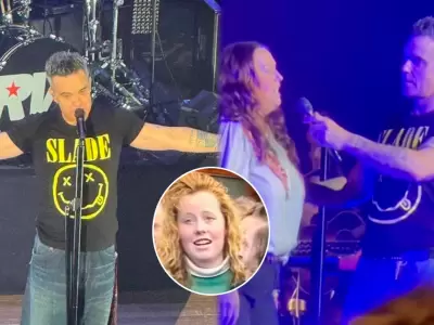 Robbie Williams sube a escenario a fan que le grit� su n�mero hace 30 a�os.